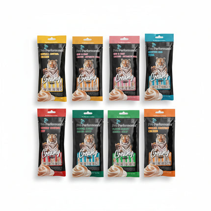 Six packages of Pro Performance cat treats with tiger branding on a textured surface.