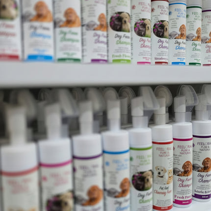 Row of pet care products on a shelf with visible branding.